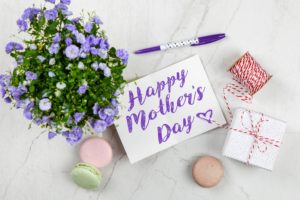 pretty photo with flowers and macaroons and a card that says happy Mother's Day